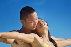 feliz pareja joven disfrutando del verano en la playa foto