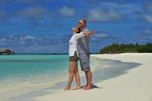 happy young couple have fun on beach photo