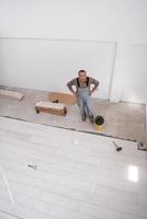 worker installing the ceramic wood effect tiles on the floor photo