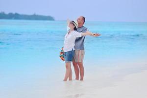 happy young couple have fun on beach photo