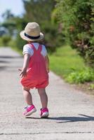 little girl runing in the summer Park photo