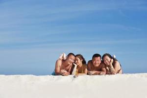 group of happy young people have fun on bach photo