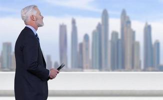 Senior businessman in front of the big city photo