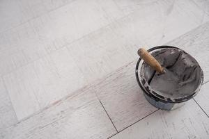 Ceramic wood effect tiles and tools for tiler on the floor photo