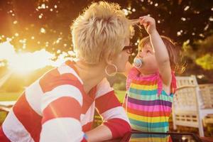 mom and her little daughter using tablet computer photo