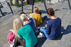 students outside sitting on steps photo