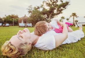 mother and little daughter playing at backyard photo