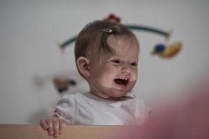 cute  little one year old baby and making first steps in bed photo