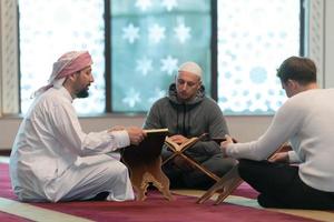 muslim people in mosque reading quran together photo