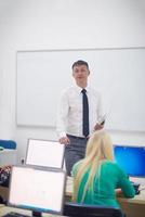 estudiantes con profesor en aula de laboratorio de computación foto