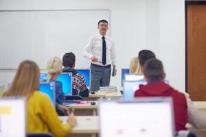 students with teacher  in computer lab classrom photo