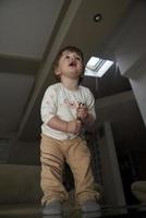 Adorable cute beautiful little baby girl playing with toys at home photo