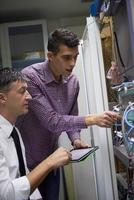 network engineers in server room photo