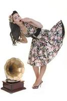 pretty girl listening music on old gramophone photo