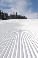 tracks on ski slopes at beautiful sunny  winter day photo