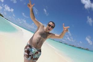 young man have fun and relax on beach photo