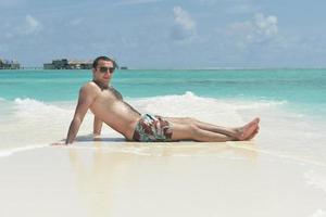 young man have fun and relax on beach photo