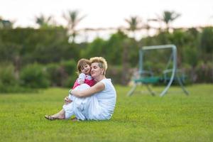 mother and little daughter playing at backyard photo