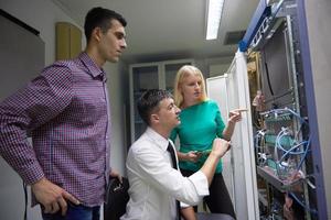 network engeneers working in network server room photo