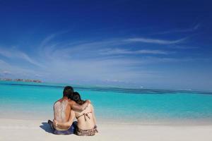 happy young  couple enjoying summer on beach photo