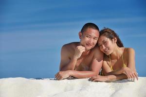 happy young  couple enjoying summer on beach photo