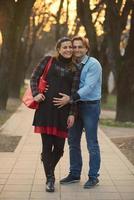 young pregnant couple have fun and relax photo