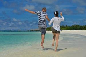 happy young couple have fun on beach photo