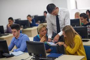 students with teacher  in computer lab classrom photo