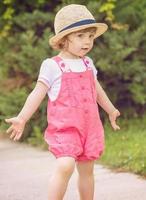 little girl runing in the summer Park photo