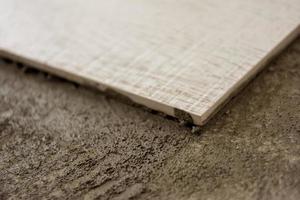 Ceramic wood effect tiles and tools for tiler on the floor photo