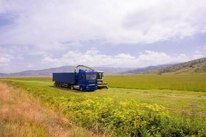 combine machine loading bunker of the truck photo