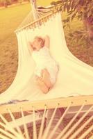 young woman resting on hammock photo