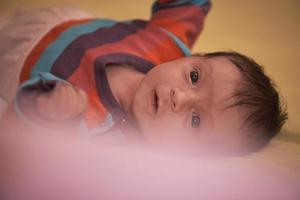 One month newborn baby sleeping  in bed photo