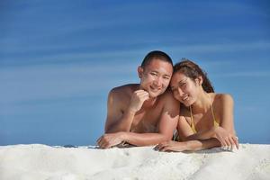 happy young  couple enjoying summer on beach photo