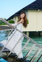 asian bride on beach photo