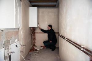 engineer checking technical data of heating system