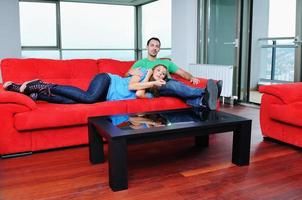 happy couple relax on red sofa photo