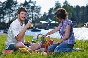 happy young couple having a picnic outdoor photo