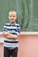 happy young boy at first grade math classes photo