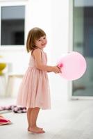 cute little girl playing with balloons photo