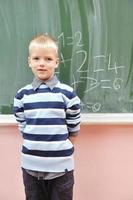 happy young boy at first grade math classes photo