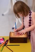 little girl painting jewelry box photo