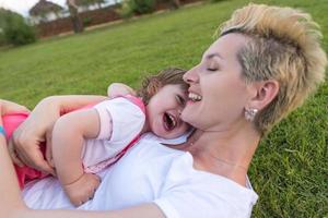 mother and little daughter playing at backyard photo