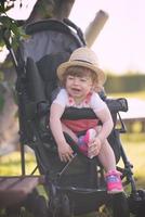 baby girl sitting in the baby stroller photo