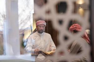 muslim people in mosque reading quran together photo