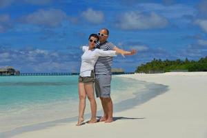 happy young couple have fun on beach photo