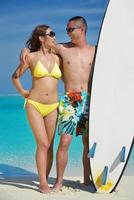 happy young  couple enjoying summer on beach photo