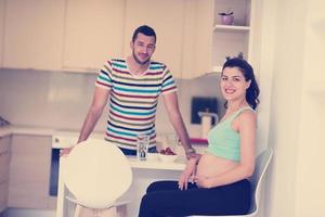 couple eating fruit strawberries at kitchen photo