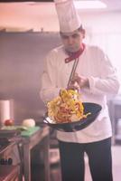 chef flipping vegetables in wok photo