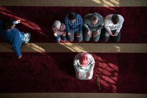 group of muslim people praying namaz in mosque. photo